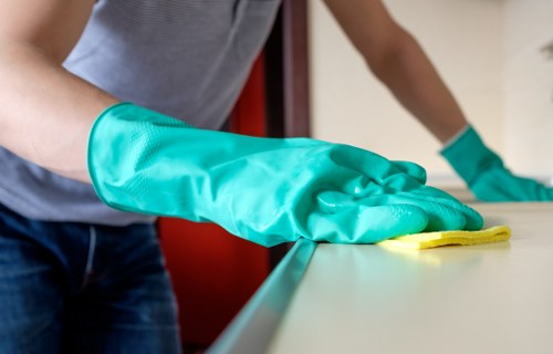PPE-equipped carpet cleaning team working safely in a property